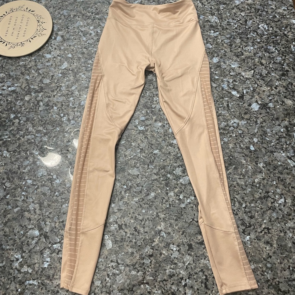 Tan leggings with mesh cuts down the entire leg